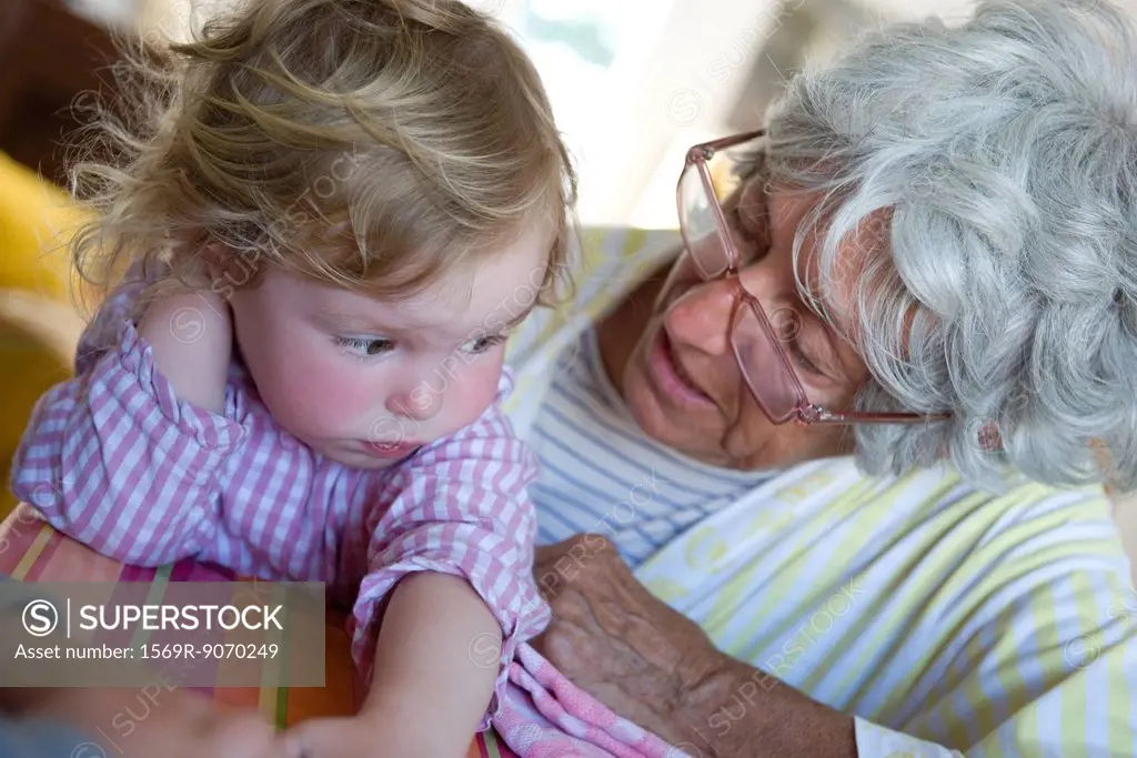 Grandmother comforting toddler granddaughter