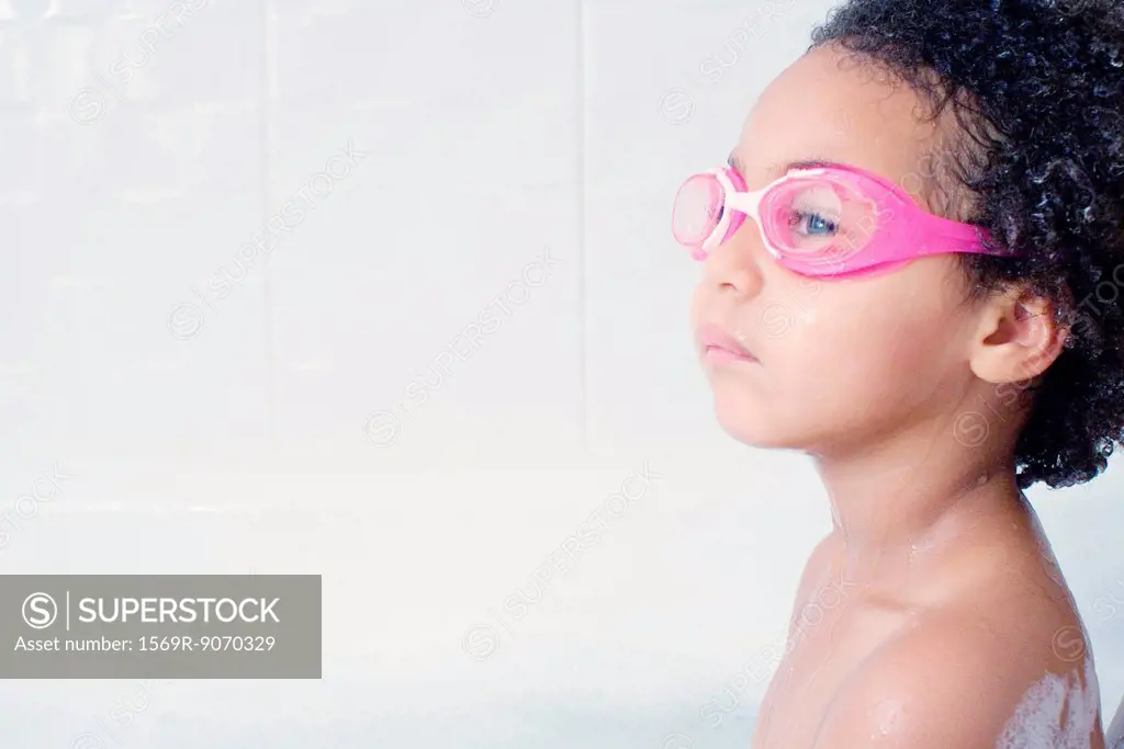 Little girl with swimming goggles in bath
