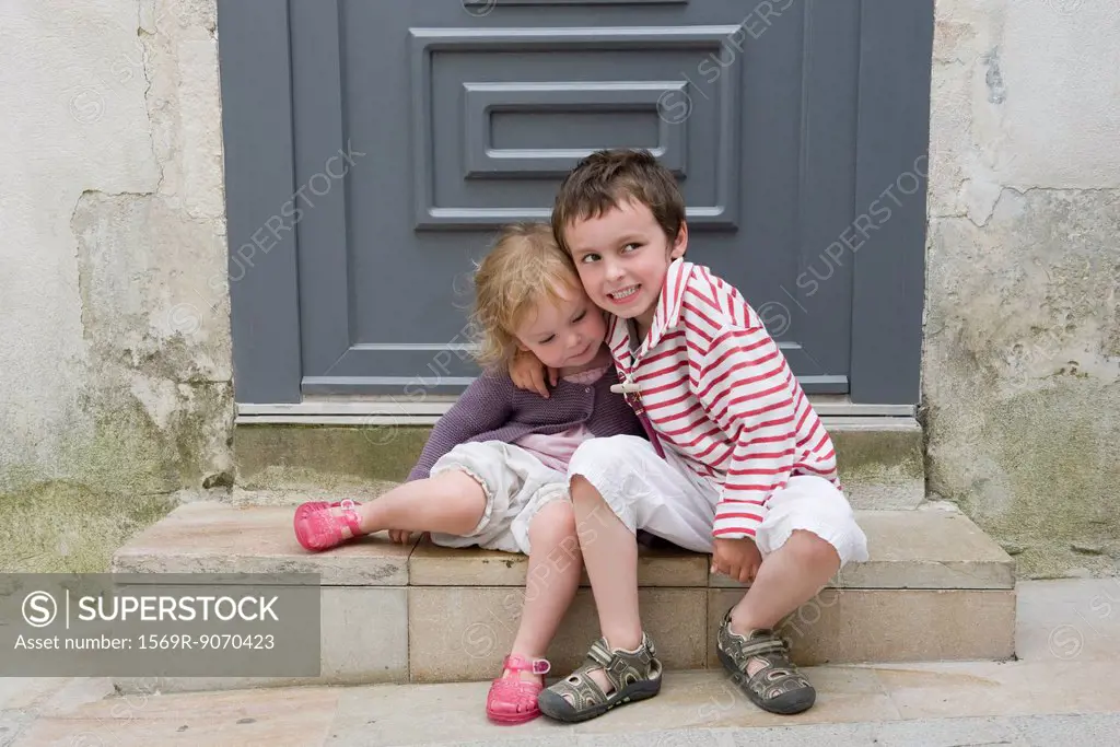 Young brother and sister embracing, portrait