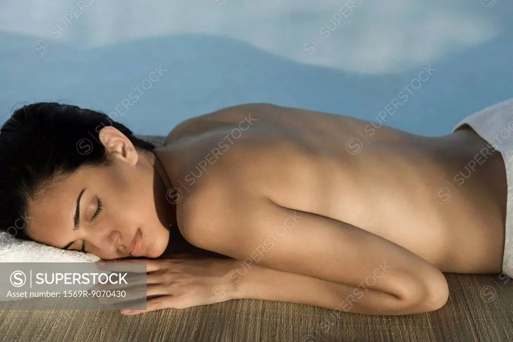 Woman lying in shade with eyes closed