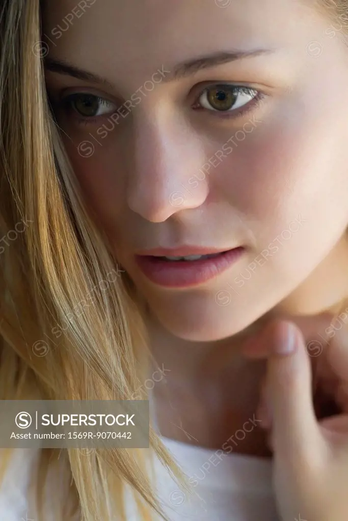 Woman looking away dreamily, portrait