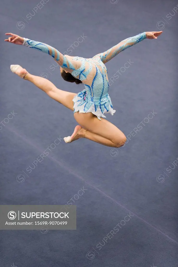 Female gymnast jumping in midair