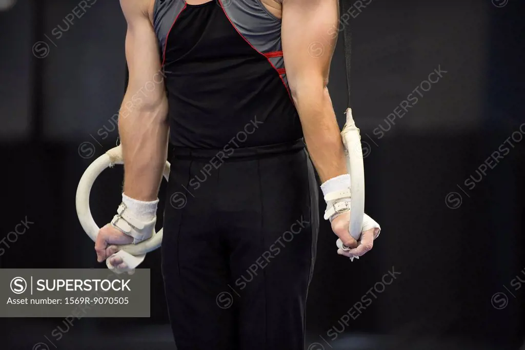 Male gymnast on the rings, cropped