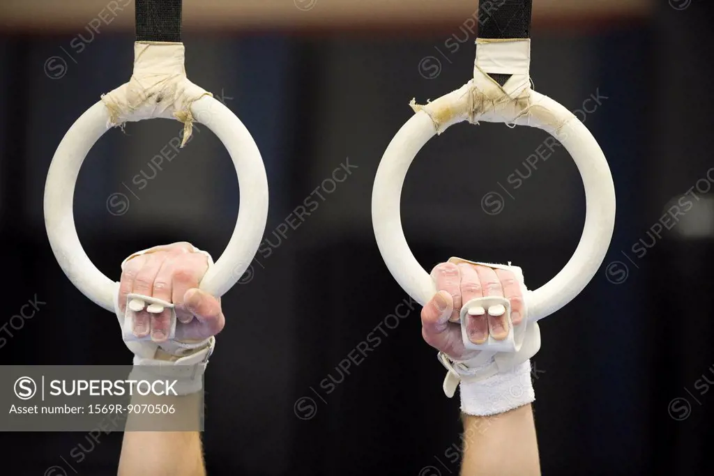 Gymnast´s hands gripping the rings, cropped