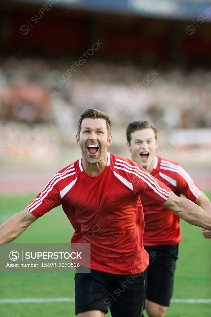 Soccer players shouting in victory