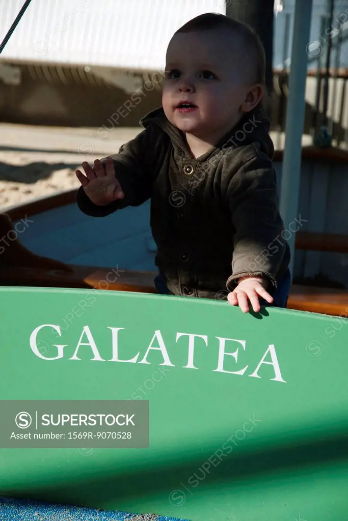 Toddler playing in boat