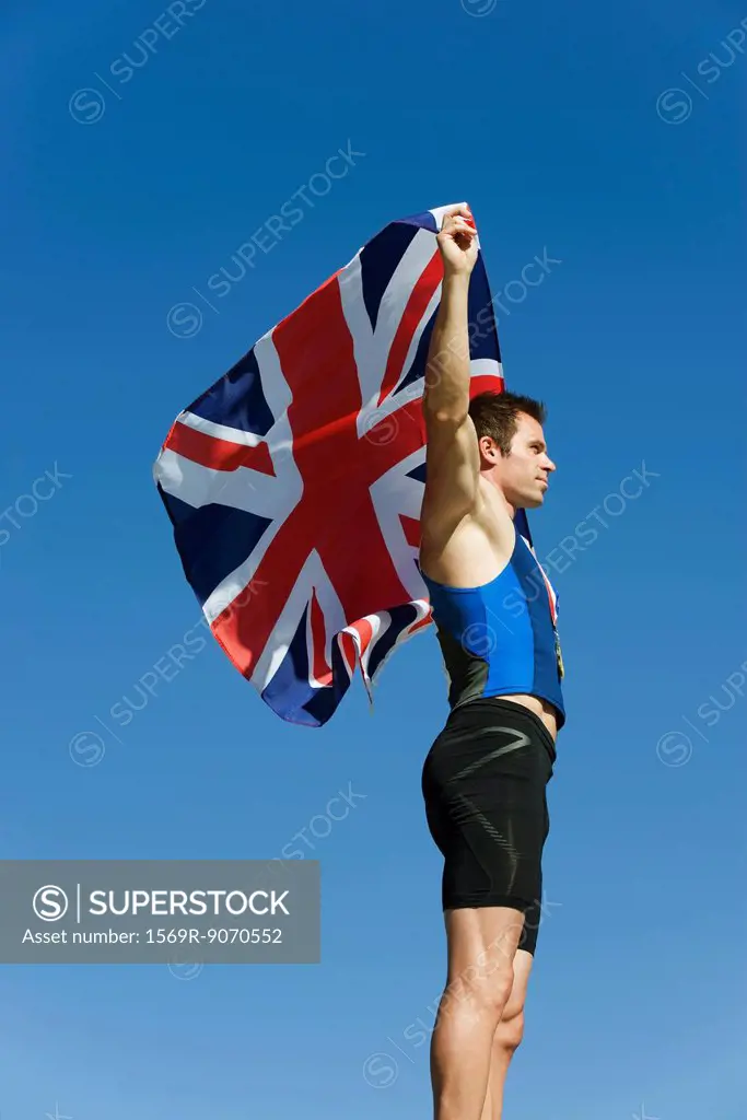 Male athlete holding up British flag