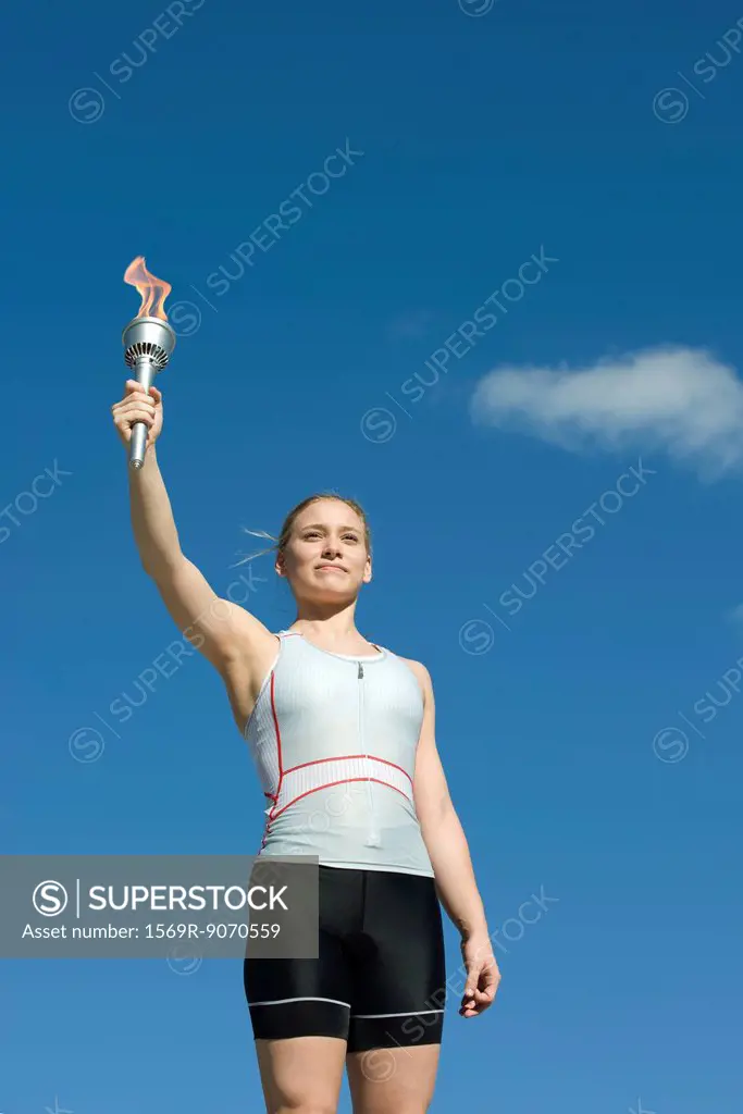 Female athlete holding up torch