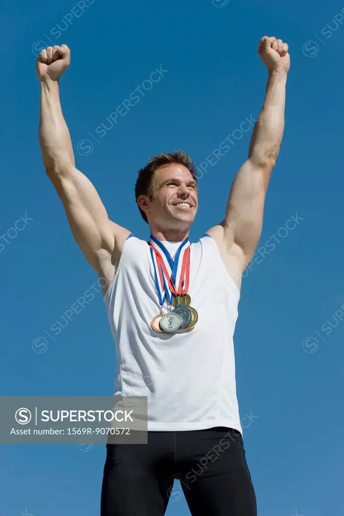 Male athlete with arms raised in victory