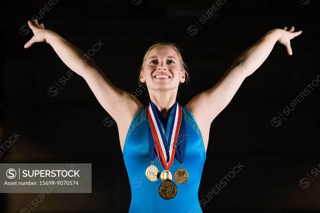 Female gymnastic medalist taking bow, portrait