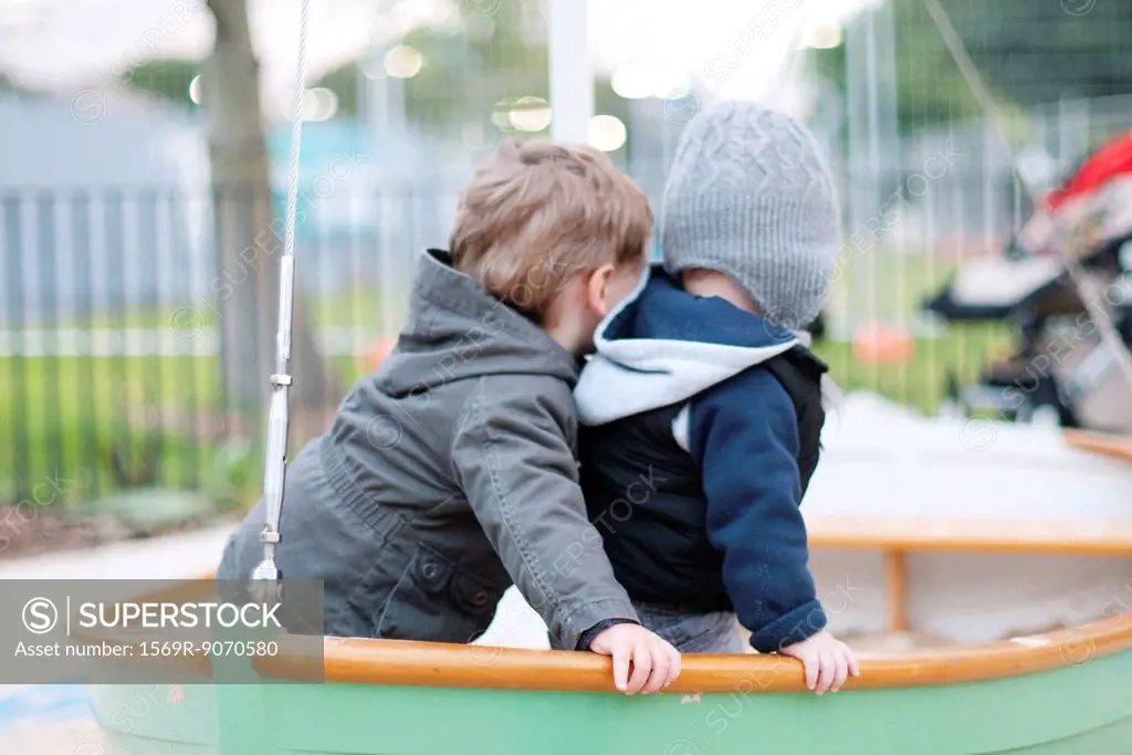Toddler boys playing on playground