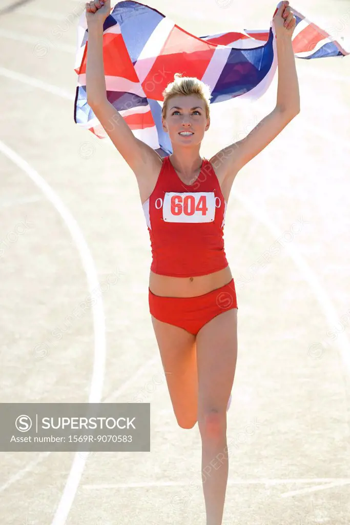 Woman running on track with British flag