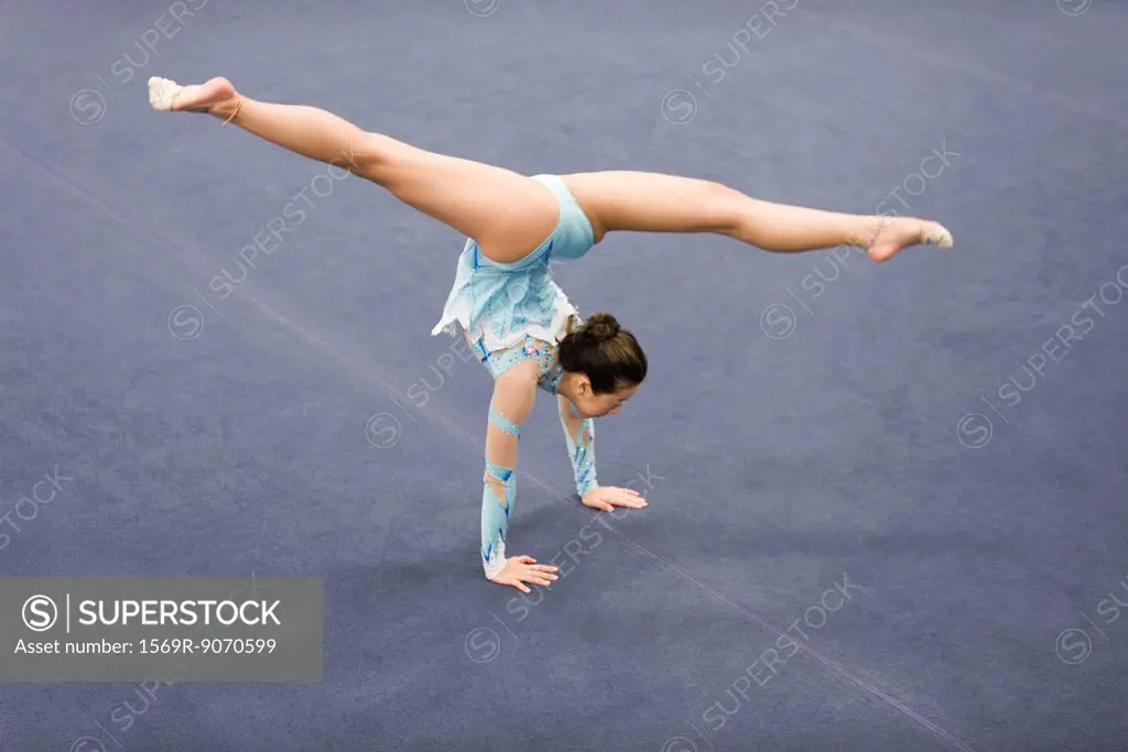 Female gymnast performing handstand