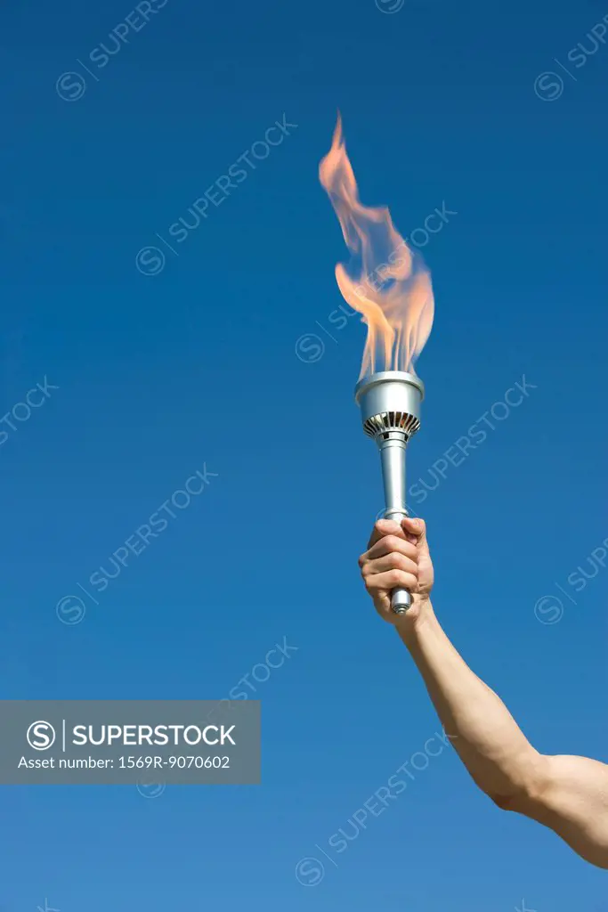 Man´s arm holding up torch