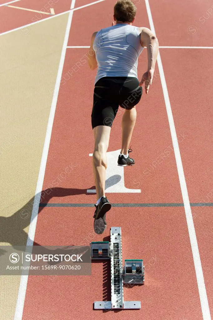 Man running on track, rear view