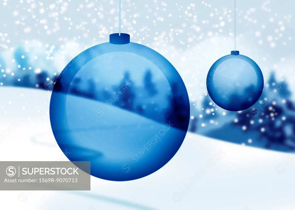 Transparent blue Christmas ornaments with snowy countryside in background