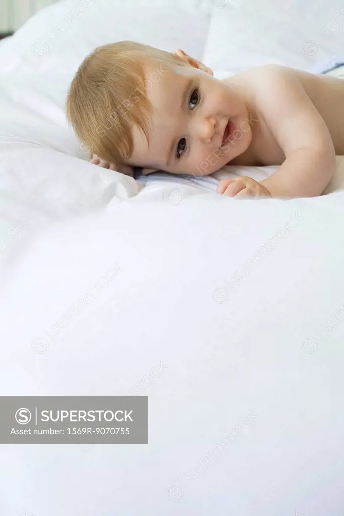 Baby lying on bed
