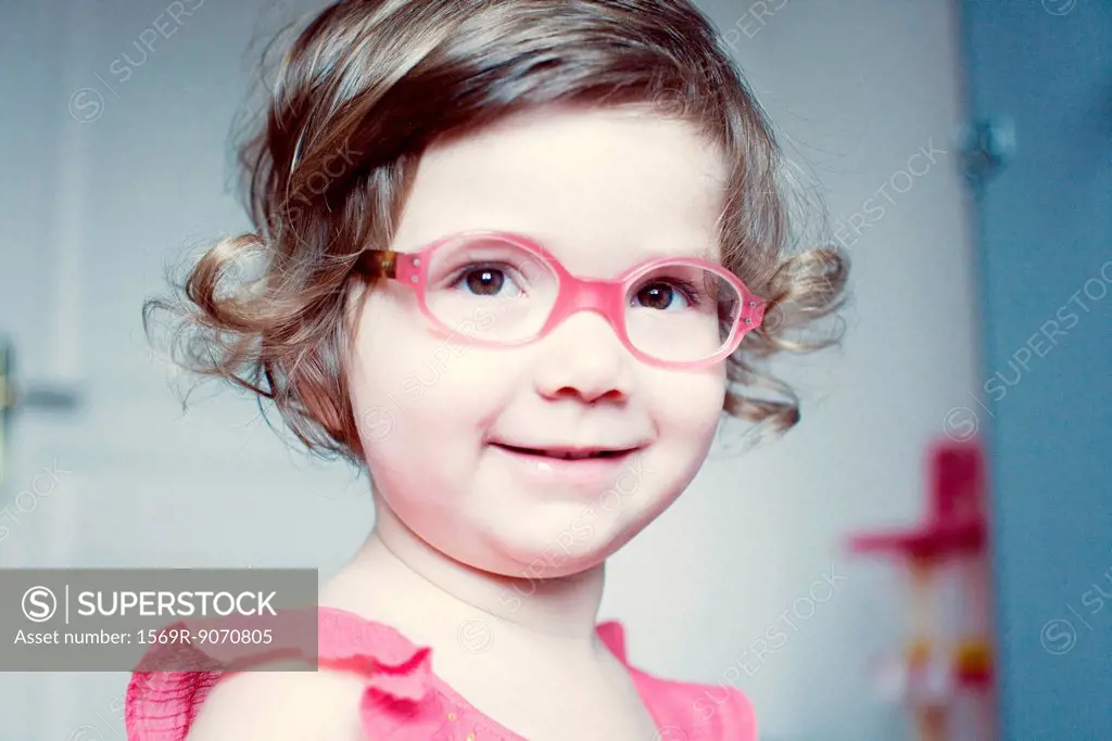 Little girl with glasses smiling, portrait