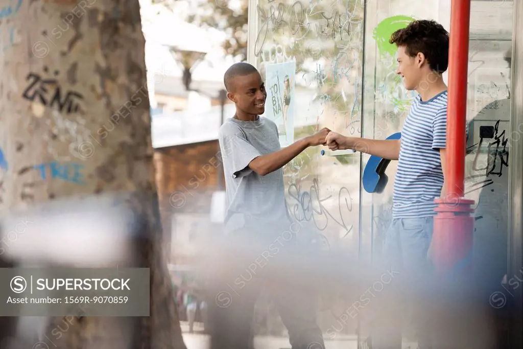 Young men greeting each other with fist bump