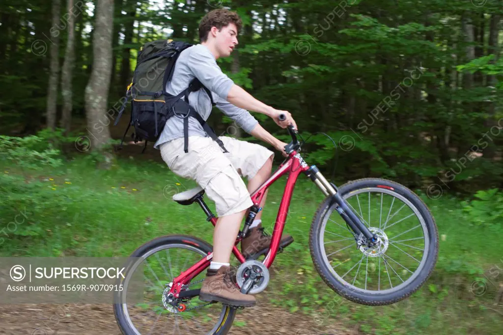 Man performing wheelie on mountain bike