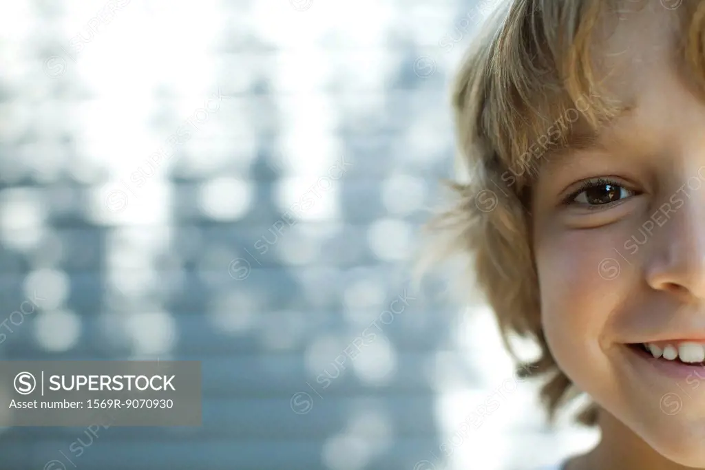 Boy smiling at camera, cropped portrait