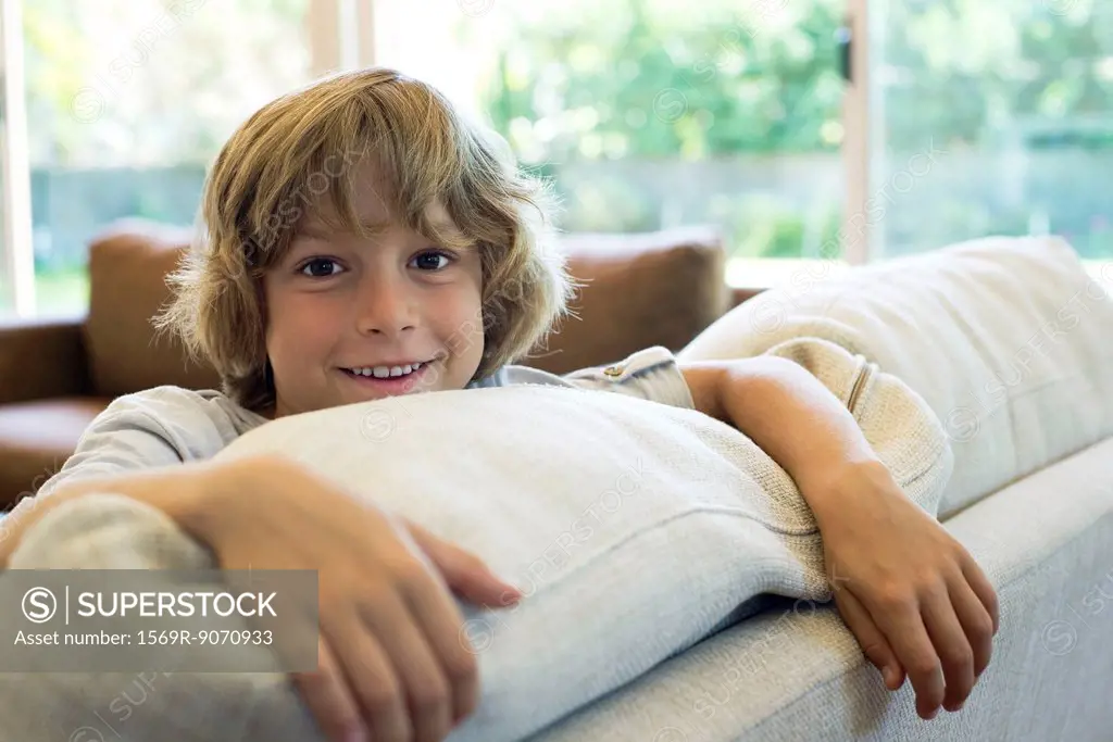 Boy leaning on sofa