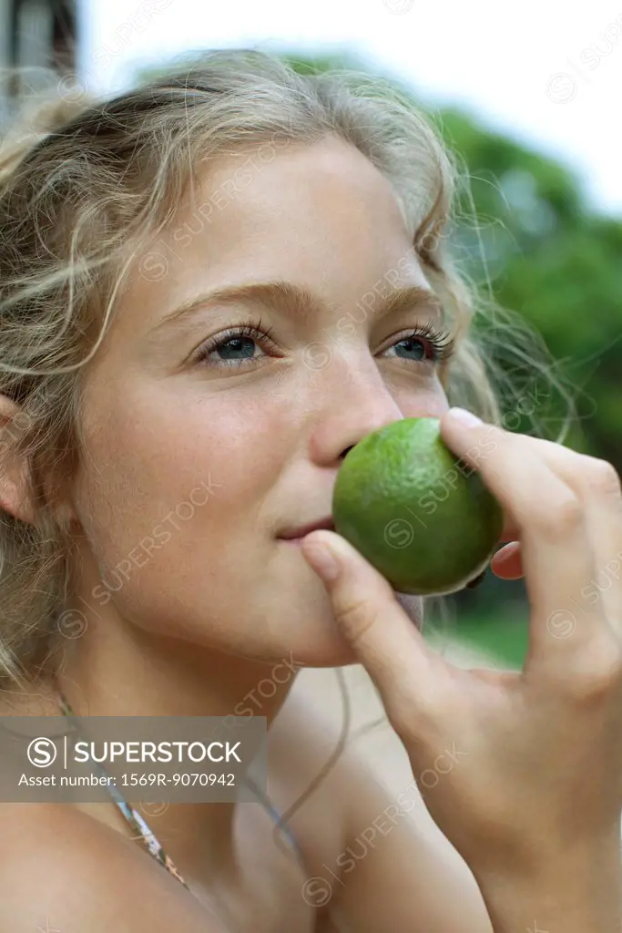 Woman smelling lime