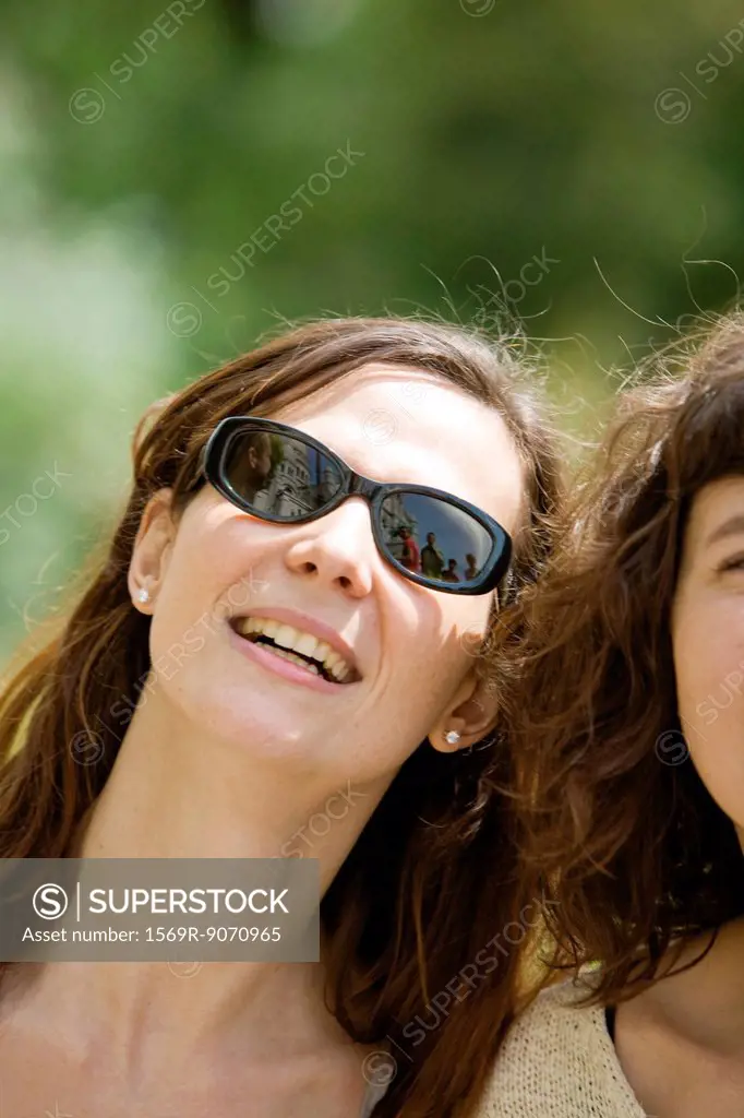 Woman beside friend, smiling, portrait