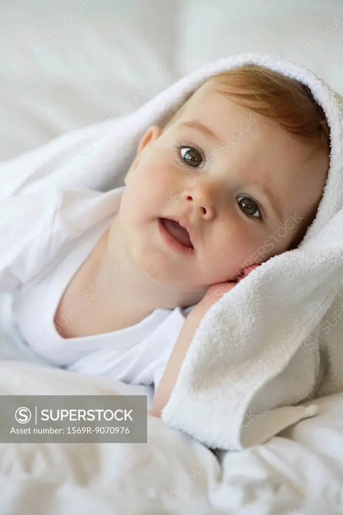 Baby with blanket on head, portrait