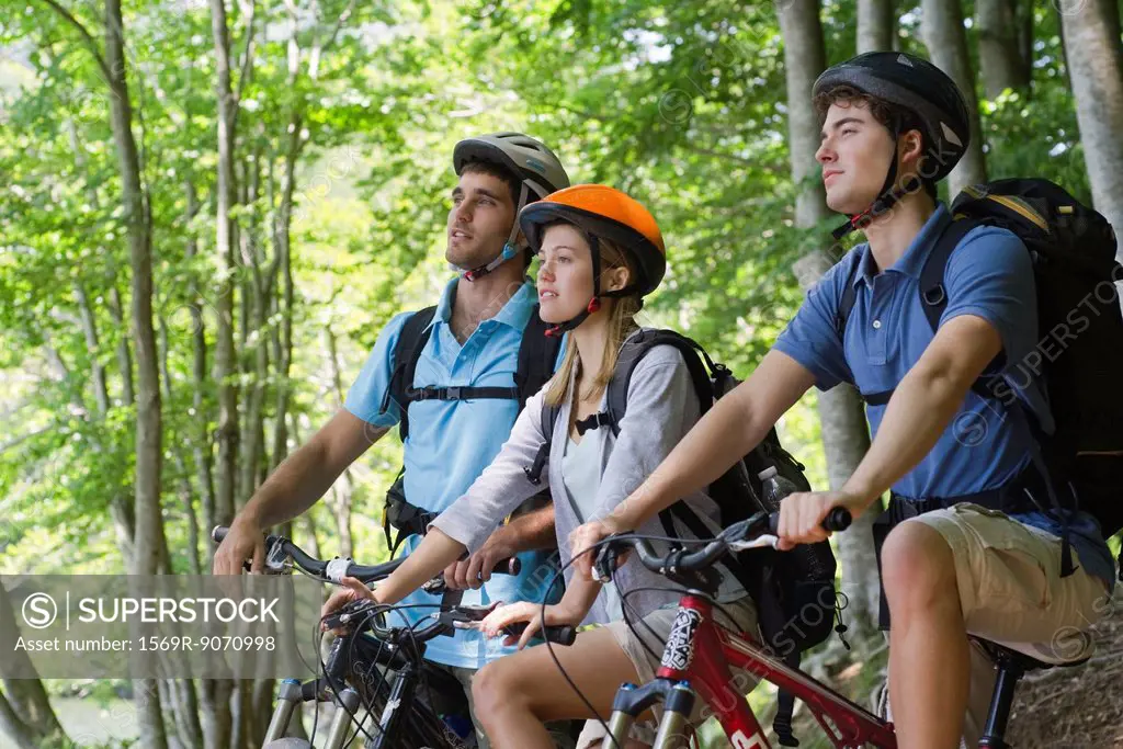 Friends bike riding in woods