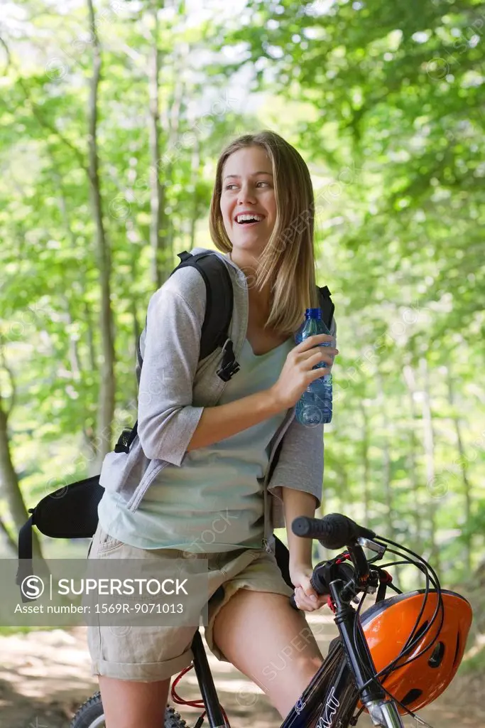Woman bike riding in woods, portrait