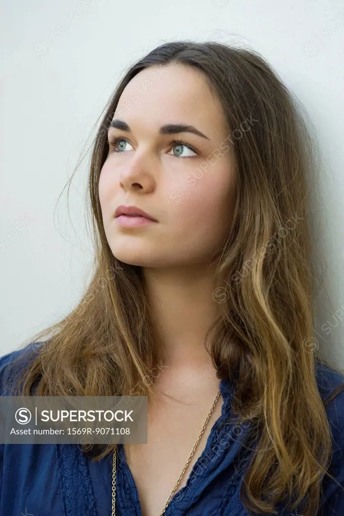 Young woman daydreaming, portrait
