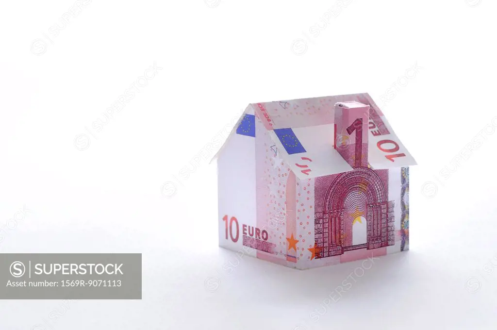 Model house folded with euro banknote