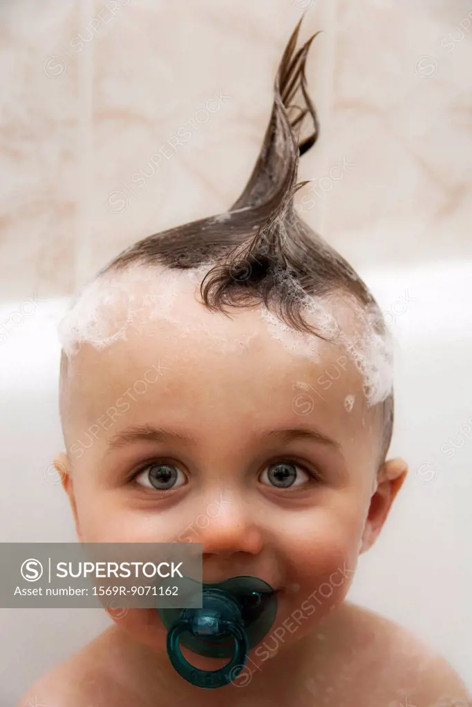 Little boy in bath with wet hair in mohawk, portrait