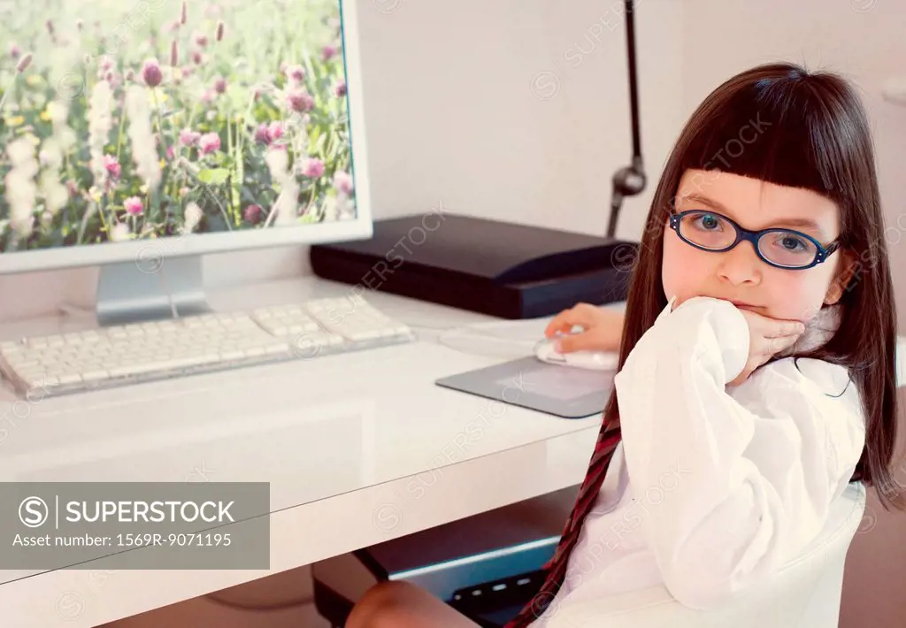 Girl sitting in front of desktop computer