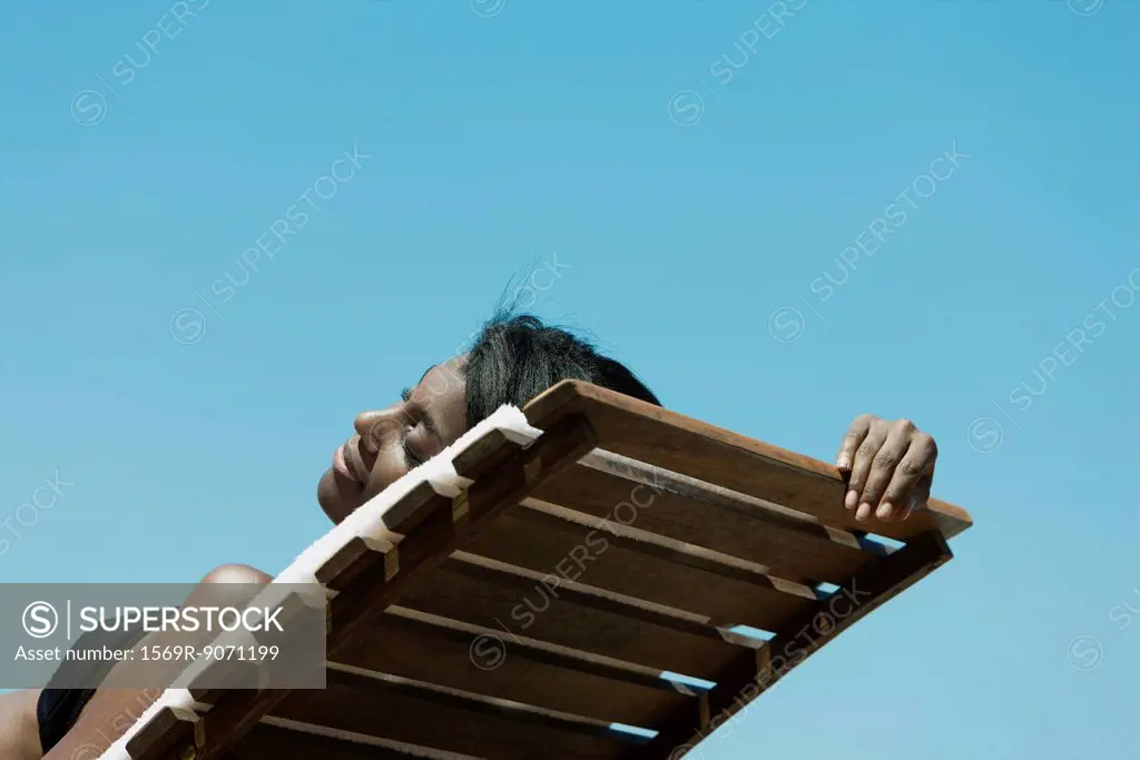 Woman sunbathing on deckchair