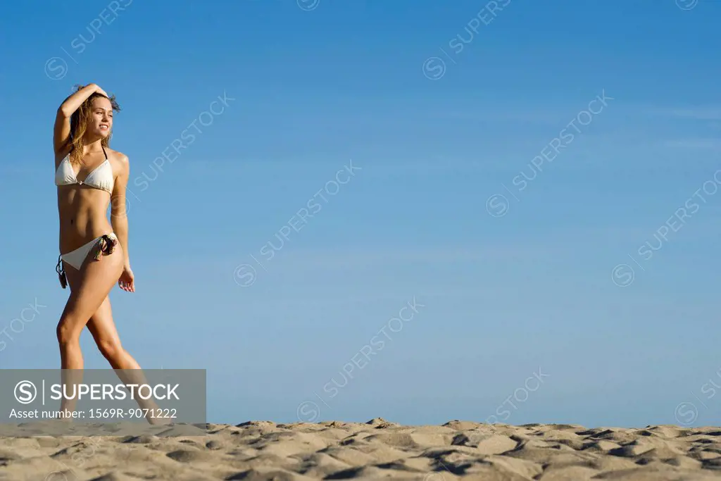Woman in bikini walking at the beach