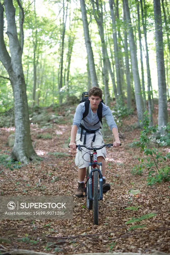 Man riding bicycle in woods