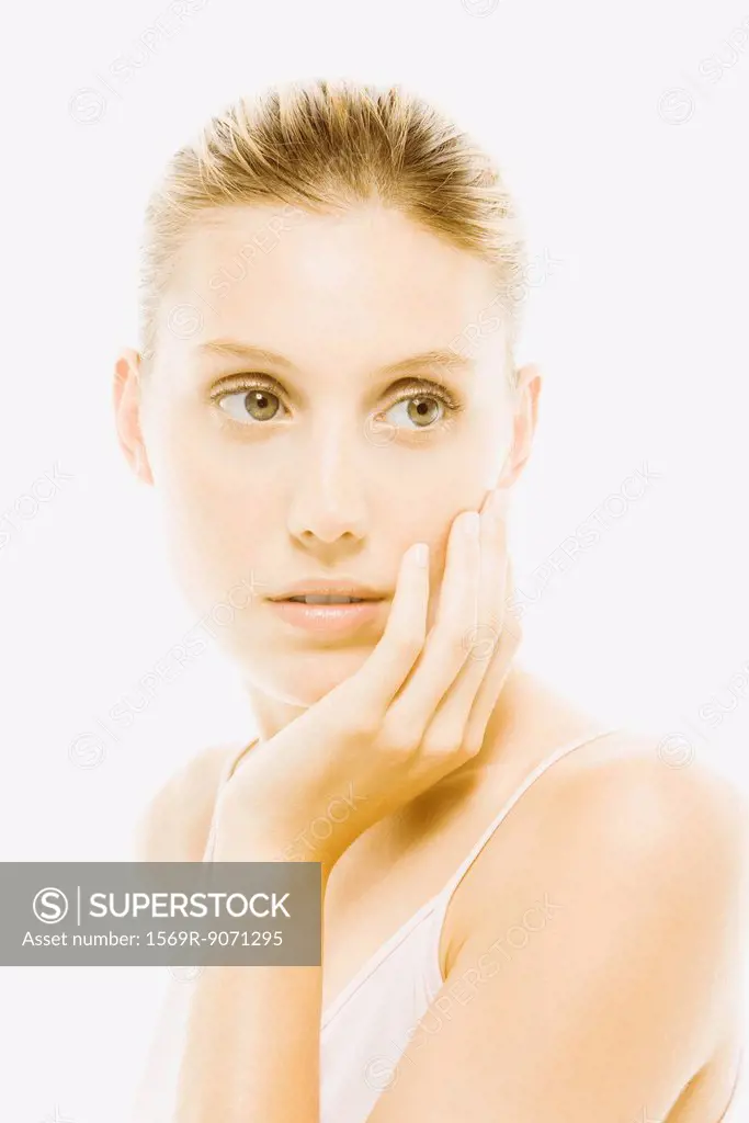 Young woman with hand under chin contemplatively looking away