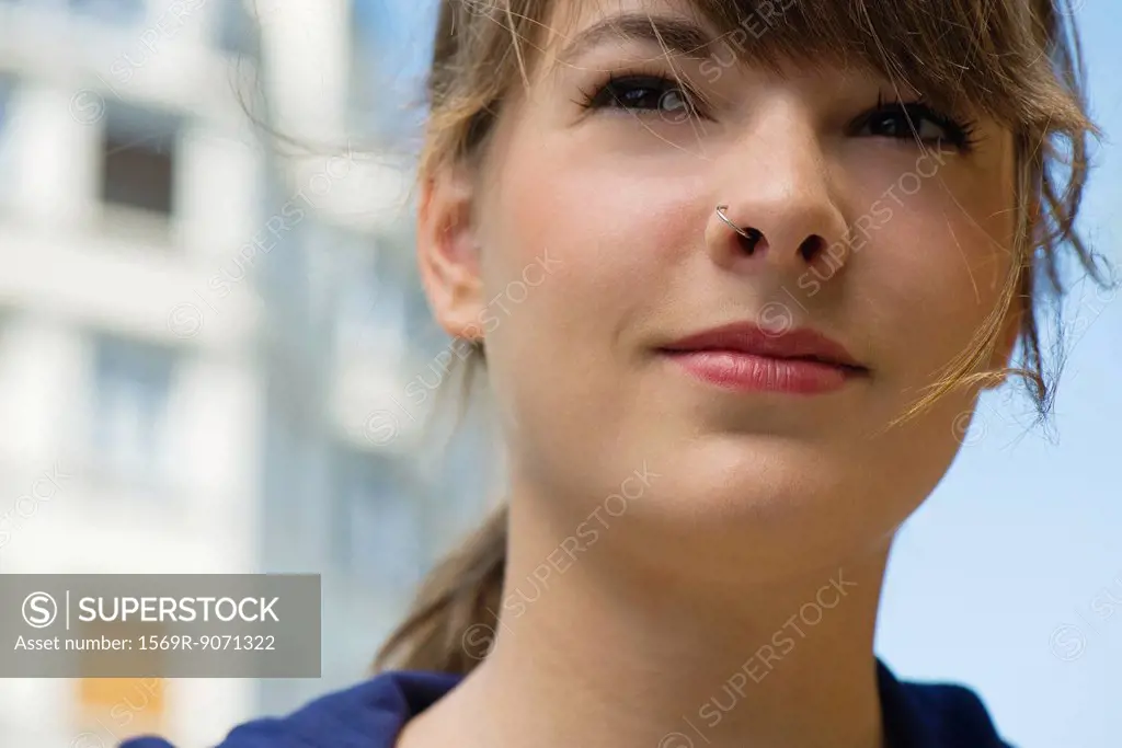 Young woman, looking away in thought, portrait