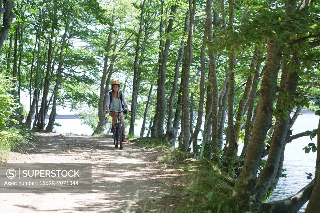 Woman riding bicycle in woods
