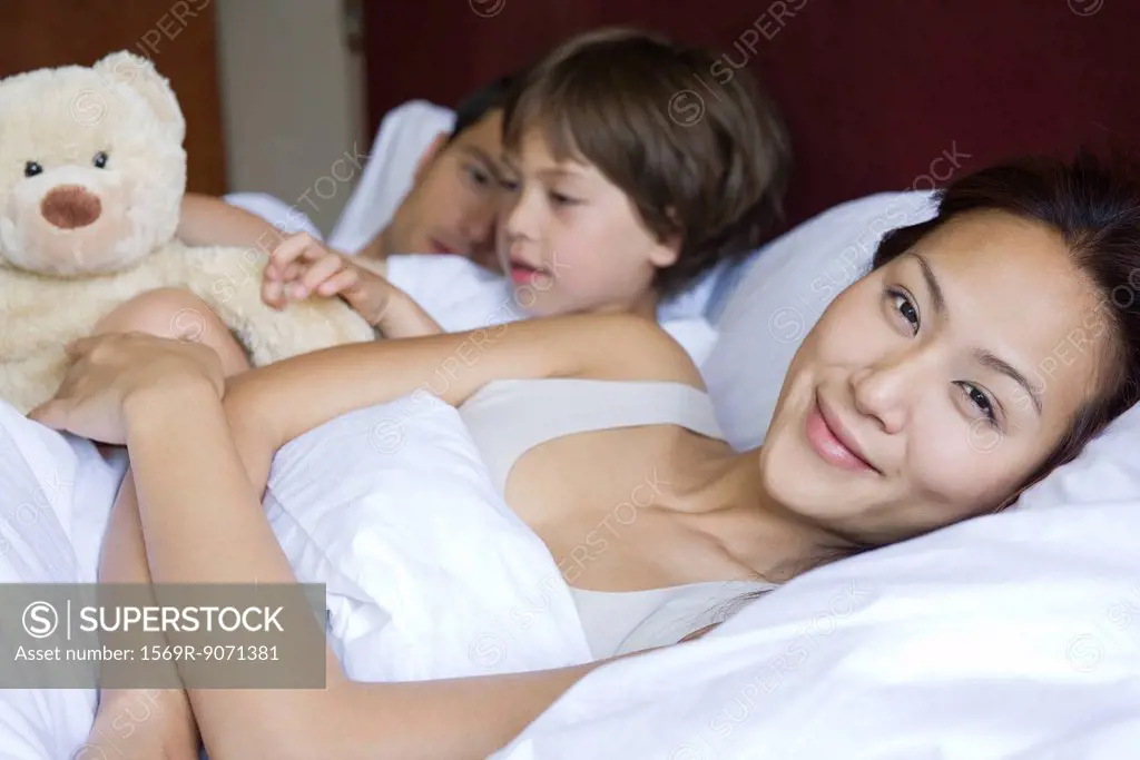Family relaxing together in bed