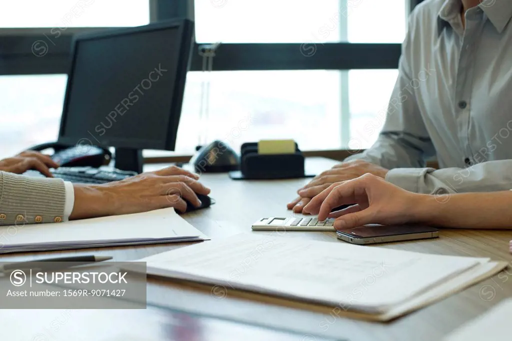 Business associates negotiating deal, cropped