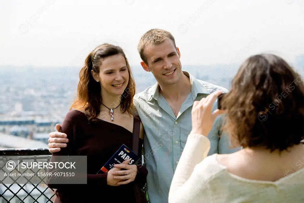 Tourist couple posing for photograph at scenic lookout