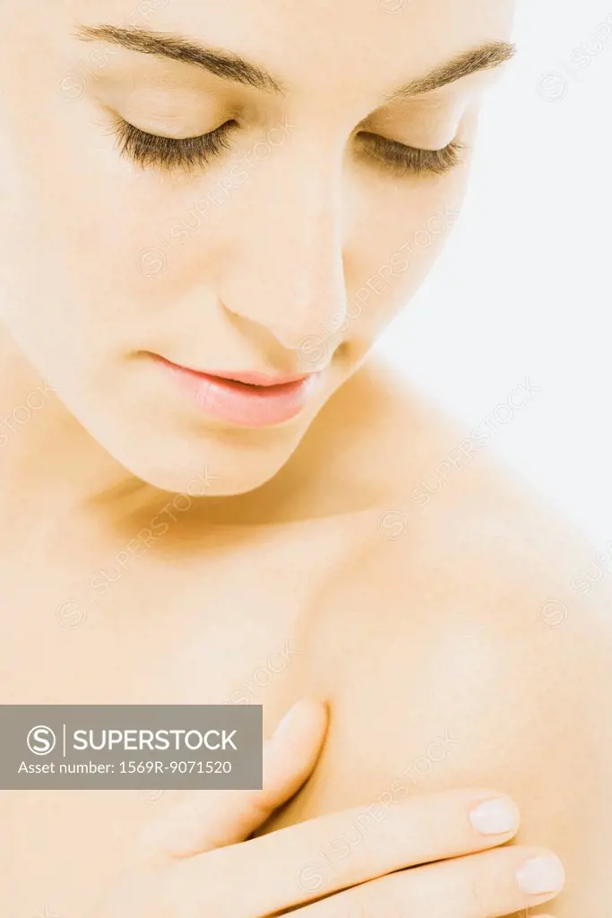 Woman touching bare shoulder, close_up