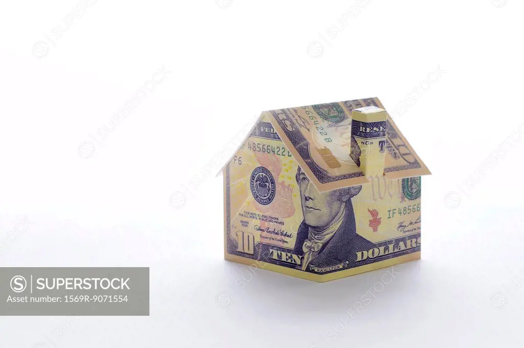 Model house folded with dollar bill