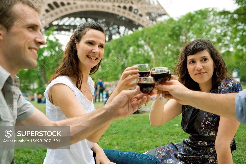 Friends clinking wine glasses outdoors