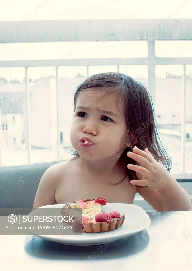 Little girl with mouth full of food