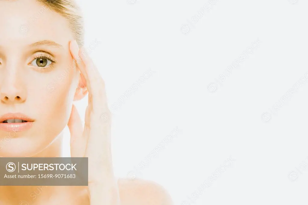 Woman with hand held to side of head, off center