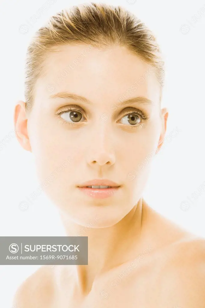 Young woman with bare shoulders, looking away, portrait